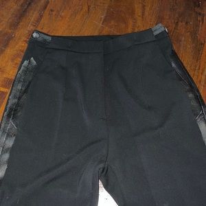Black pants with leather trim. Not sure if it’s real leather.